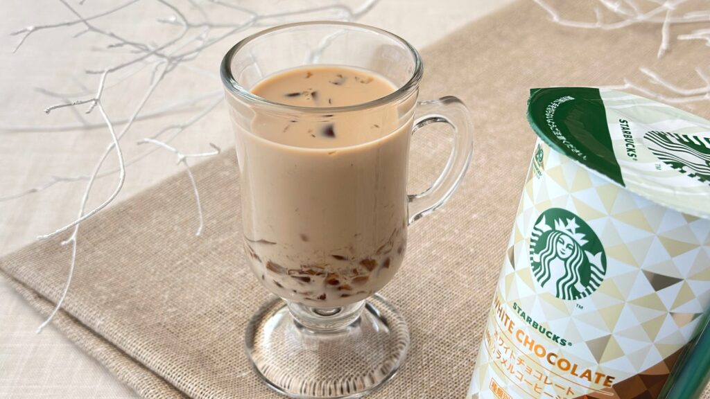 スターバックス® チルドカップ_グラスに注いだ「ホワイトチョコレート with カラメルコーヒージェリー」とパッケージが並んでいる様子