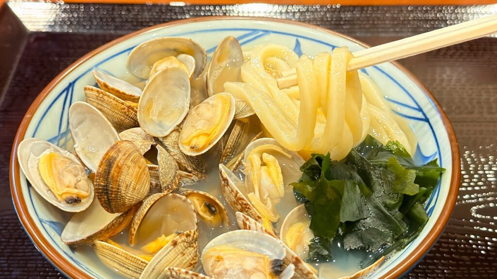 丸亀製麺_「山盛りあさりうどん」を麺を箸で持っている様子