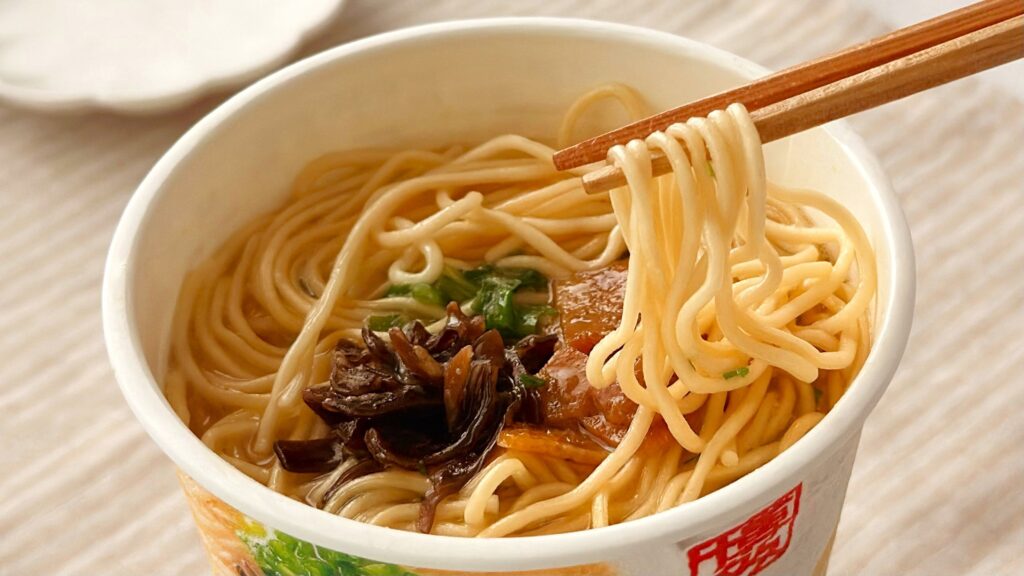 渡辺製麺_「博多豚骨ラーメン 一風堂白丸元味」の麺を箸で持っている様子